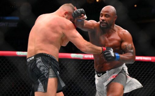 Tyrell Fortune stands in the UFC Octagon with his arm raised in victory