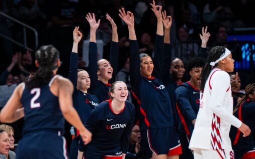 UConn women's basketball players celebrating on the court at Madison Square Garden