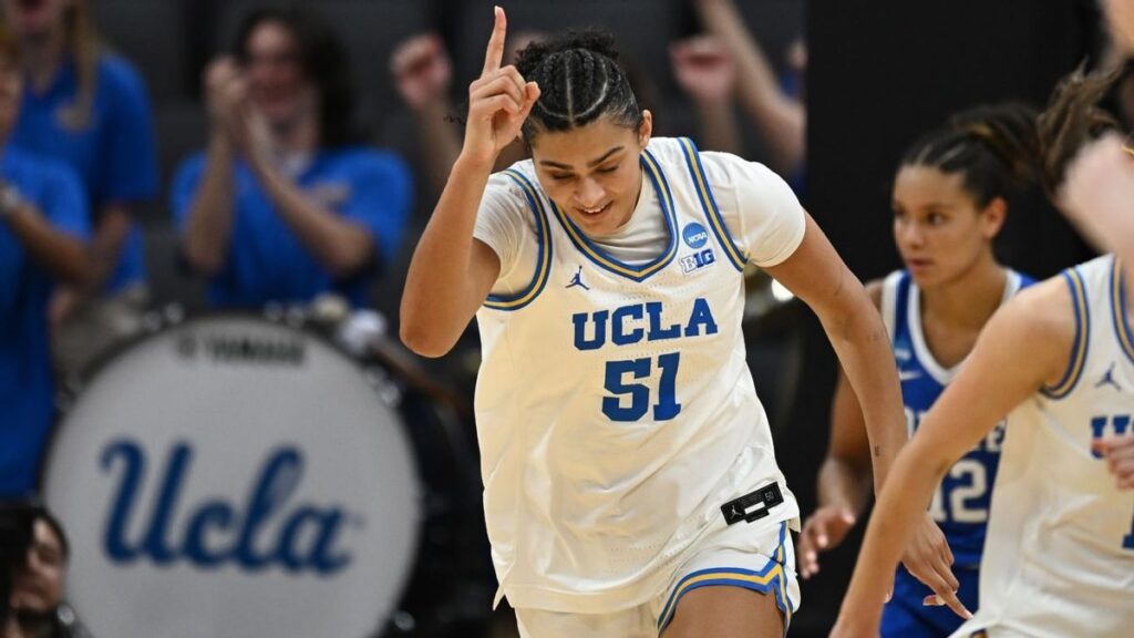 UConn Huskies players celebrating on the court during the Women's NCAA Tournament
