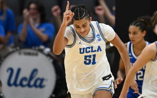 UConn Huskies players celebrating on the court during the Women's NCAA Tournament