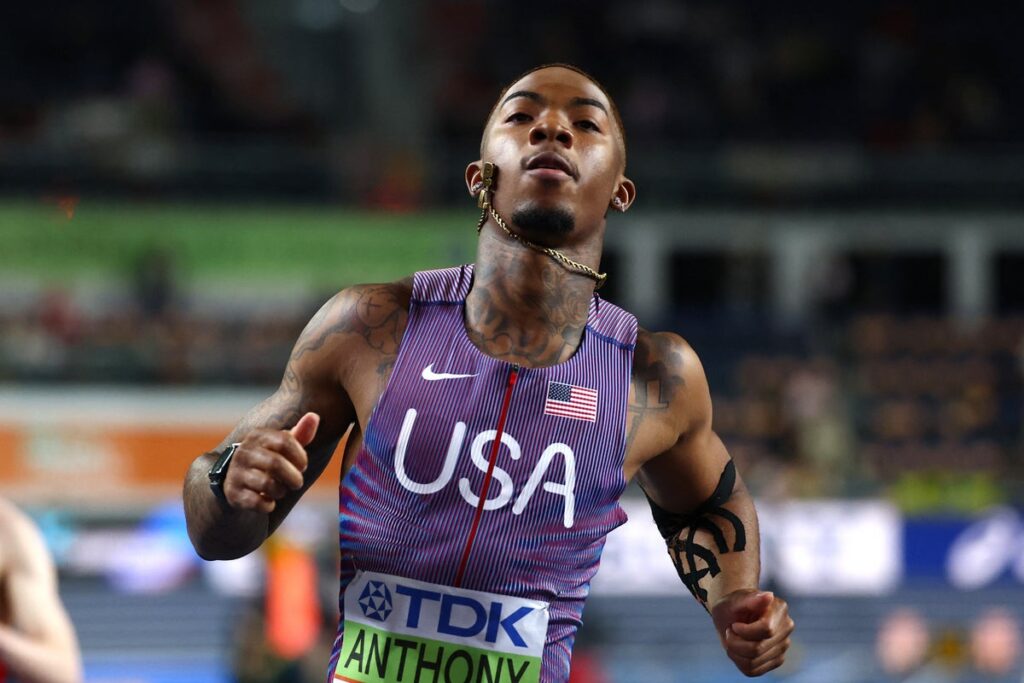 USA sprinter Jordan Anthony running on the track with a heavily taped left arm at the World Athletics Indoor Championships.