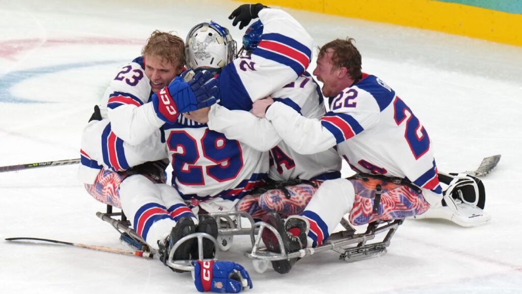 Jack Wallace and the United States Para ice hockey team celebrating their Paralympic gold medal victory in Milan Cortina