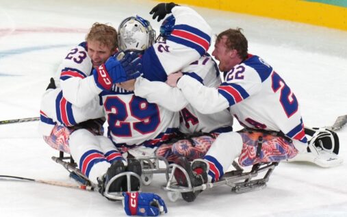 Jack Wallace and the United States Para ice hockey team celebrating their Paralympic gold medal victory in Milan Cortina