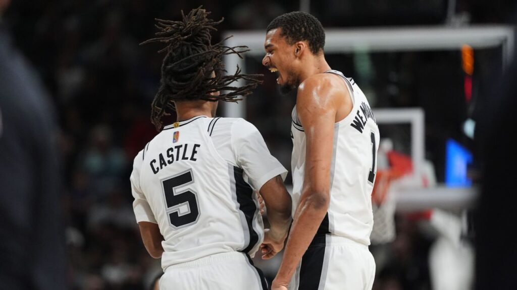 Victor Wembanyama of the San Antonio Spurs handles the basketball on the court during an NBA game.