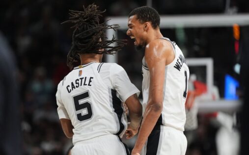 Victor Wembanyama of the San Antonio Spurs handles the basketball on the court during an NBA game.