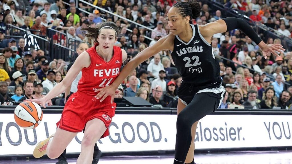 A'ja Wilson holding the WNBA MVP trophy on the basketball court