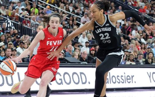 A'ja Wilson holding the WNBA MVP trophy on the basketball court