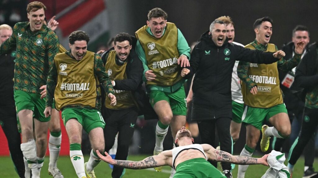 Wales and Northern Ireland football players competing on the pitch during an international match