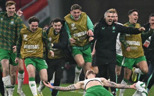Wales and Northern Ireland football players competing on the pitch during an international match