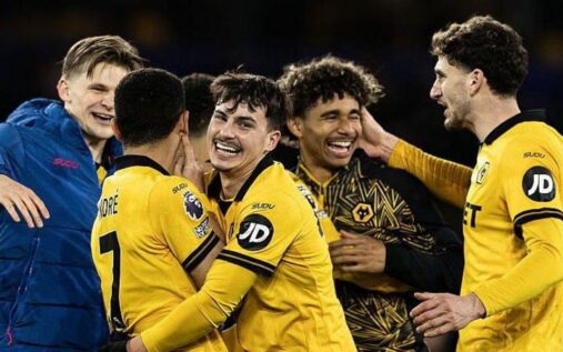 Wolverhampton Wanderers players celebrating a goal on the pitch during a Premier League match