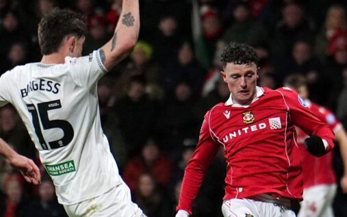 Wrexham players celebrate a goal against Swansea City in their Championship match at the Racecourse Ground