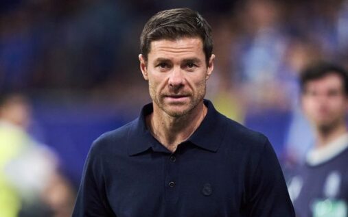 Spanish football manager Xabi Alonso looking thoughtful while standing on the touchline during a match