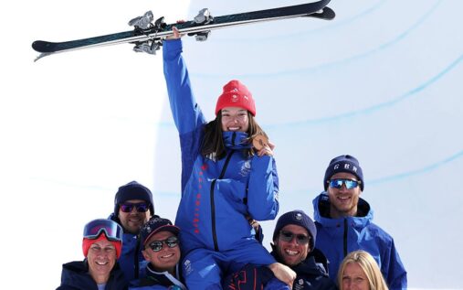 Zoe Atkin performing a trick high above the halfpipe during the Winter Olympics freestyle skiing final