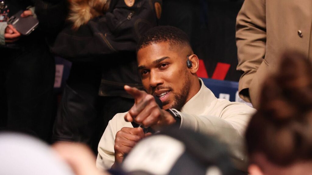 Anthony Joshua preparing for a boxing match inside the ring
