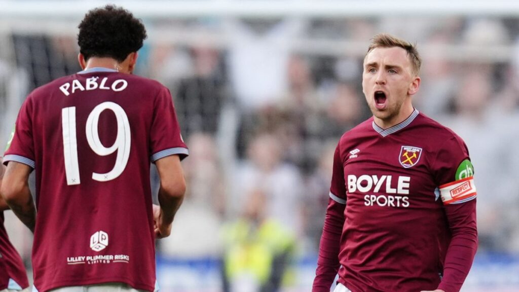 Manchester City and Arsenal players competing in a high-stakes Premier League match