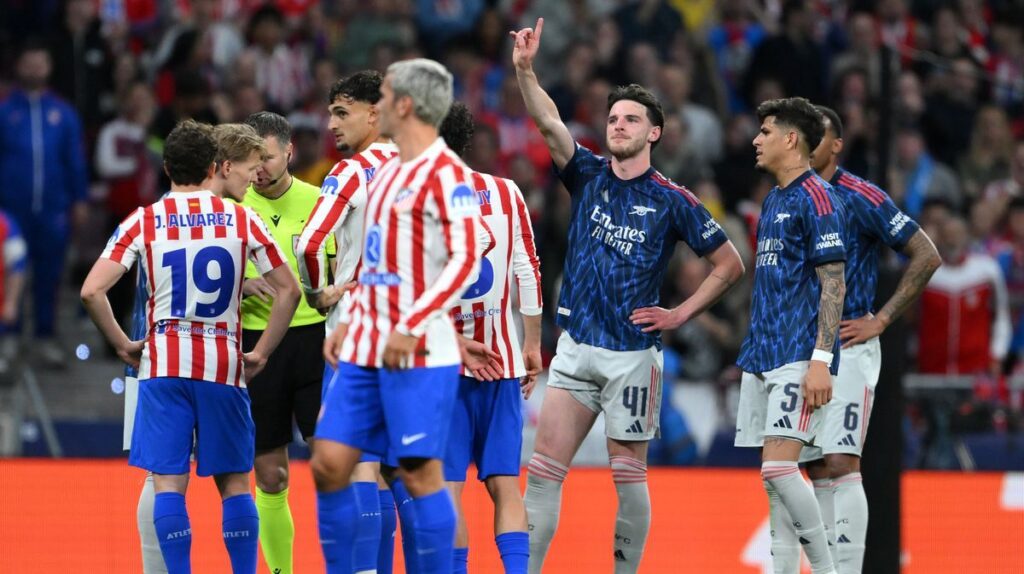 Arsenal players reacting to the referee's VAR decision during the Champions League match against Atletico Madrid