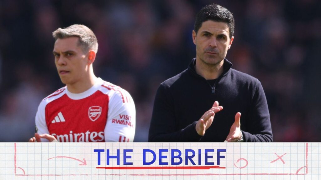Dejected Arsenal football players on the pitch during a Premier League match