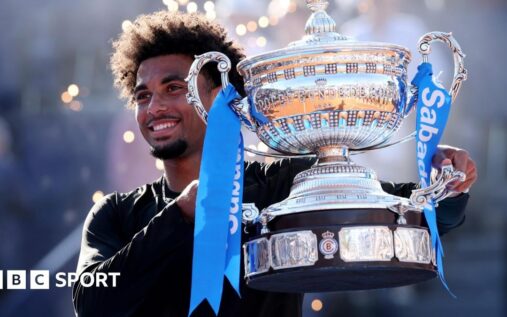 Arthur Fils celebrating with the winner's trophy on the clay court in Barcelona