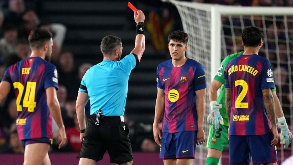 Referee Istvan Kovacs showing a red card to Barcelona defender Pau Cubarsi