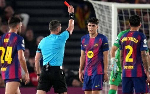 Referee Istvan Kovacs showing a red card to Barcelona defender Pau Cubarsi