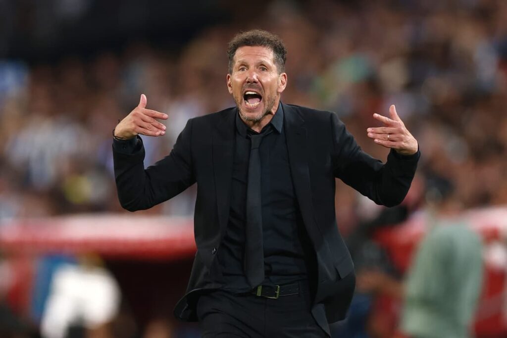 Diego Simeone shouting tactical instructions from the touchline during an Atletico Madrid Champions League match