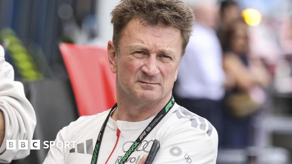 Allan McNish wearing Audi team apparel in the Formula 1 paddock