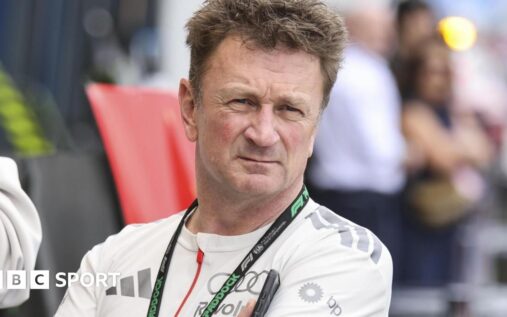 Allan McNish wearing Audi team apparel in the Formula 1 paddock