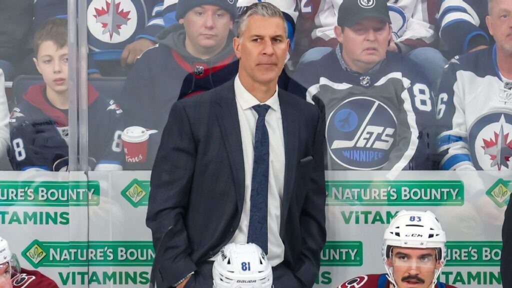 Colorado Avalanche head coach Jared Bednar standing behind the bench looking out onto the ice