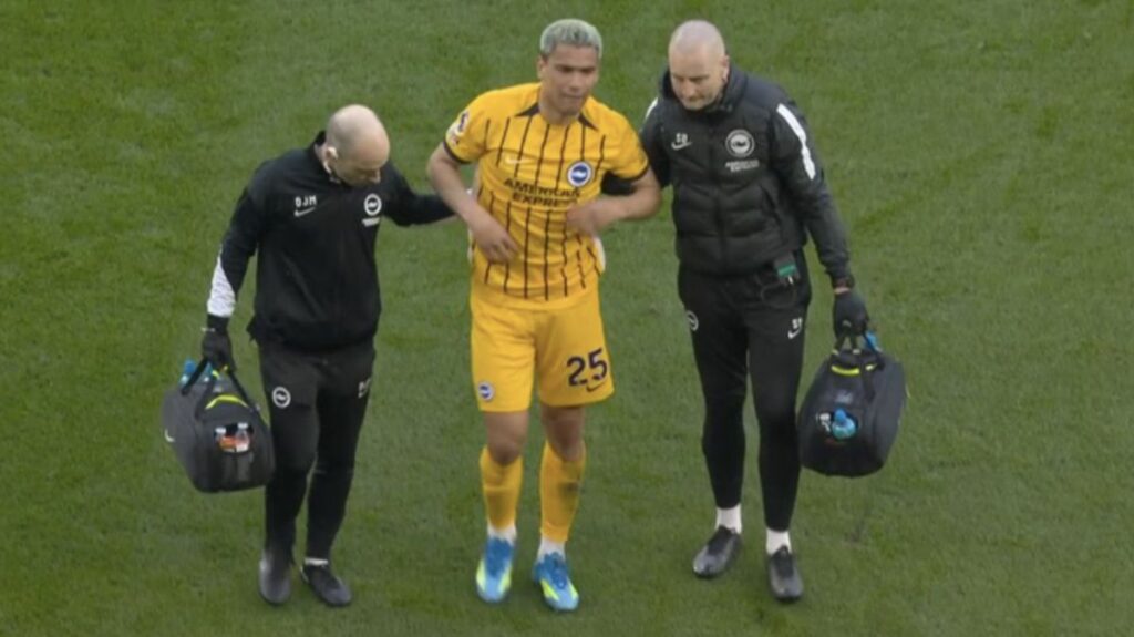 Brighton midfielder Diego Gomez receiving medical attention on the pitch