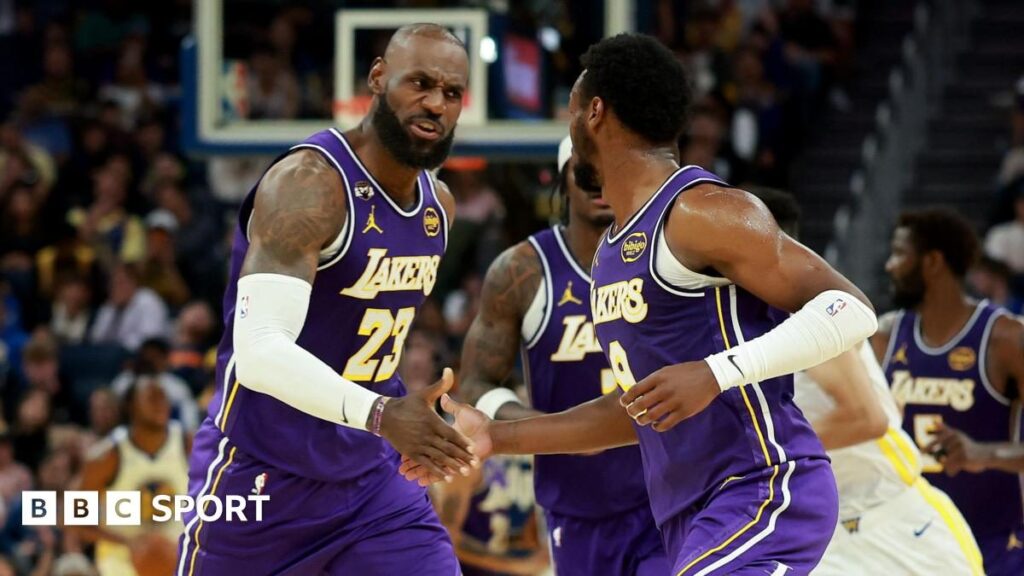 Bronny James passing the basketball to his father LeBron James during a Los Angeles Lakers game
