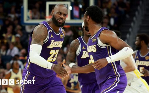 Bronny James passing the basketball to his father LeBron James during a Los Angeles Lakers game