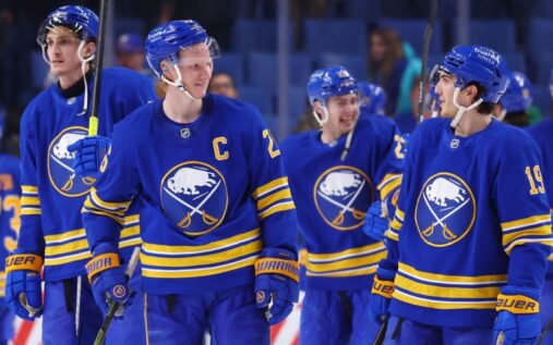 Buffalo Sabres players celebrating on the ice during an NHL match