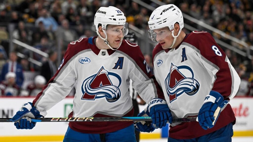 Buffalo Sabres and Boston Bruins players competing for the puck on the ice