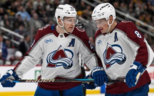 Buffalo Sabres and Boston Bruins players competing for the puck on the ice