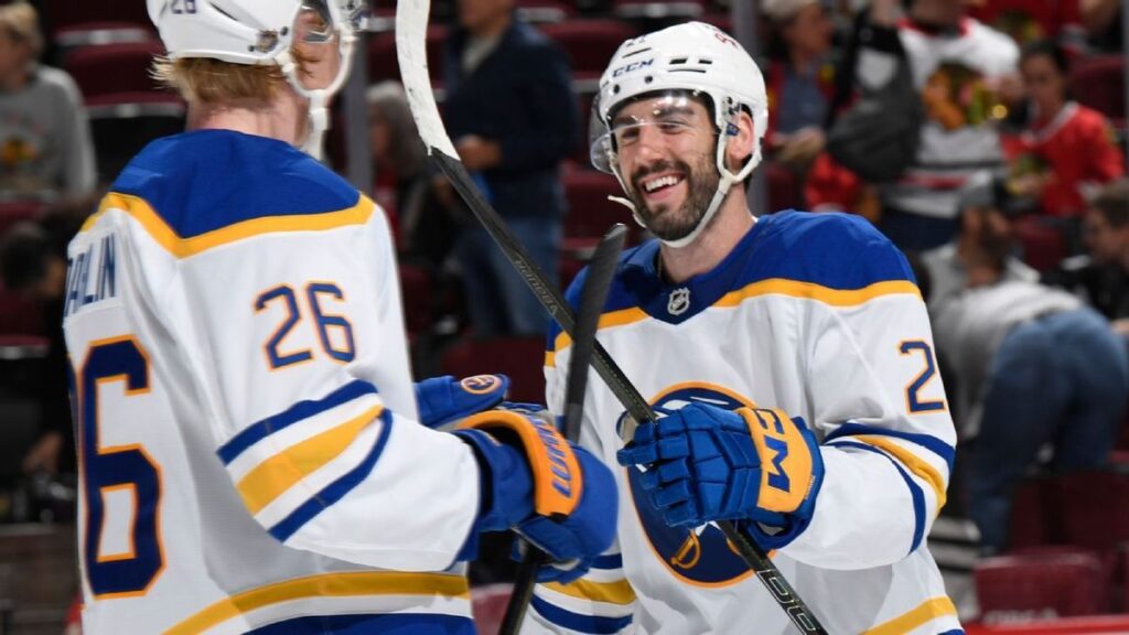 Buffalo Sabres players celebrating on the ice after winning the NHL Atlantic Division title