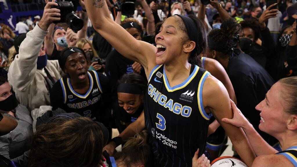Candace Parker smiling on the court during a professional basketball game