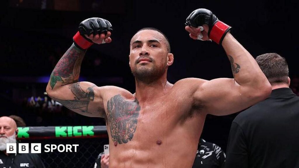 Carlos Ulberg standing in the UFC Octagon preparing for his light-heavyweight title fight against Jiri Prochazka