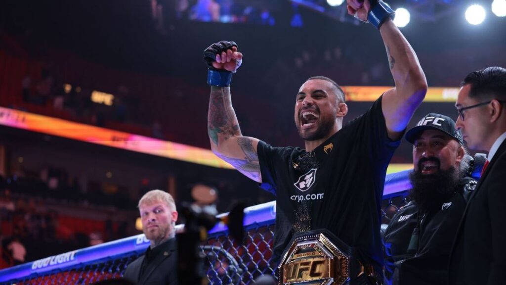UFC light heavyweight champion Carlos Ulberg celebrating a knockout victory inside the octagon
