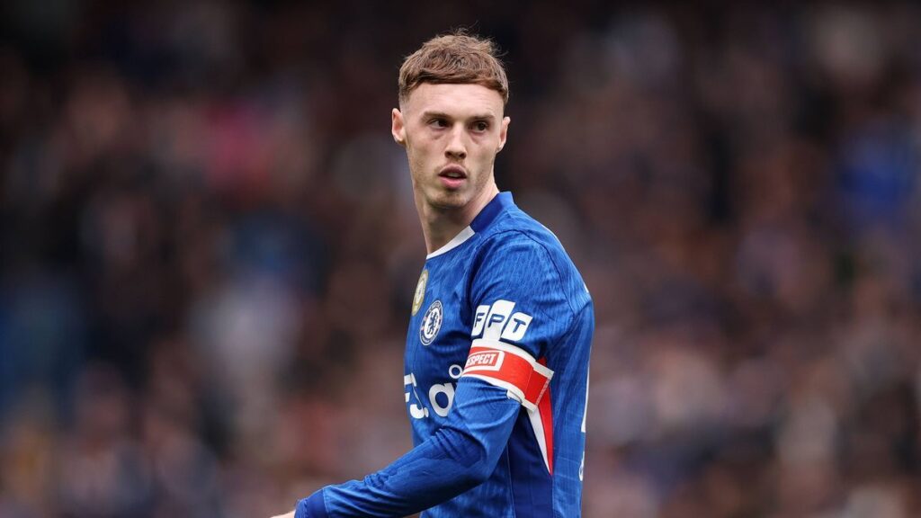 Cole Palmer looking dejected on the pitch wearing a blue Chelsea match shirt
