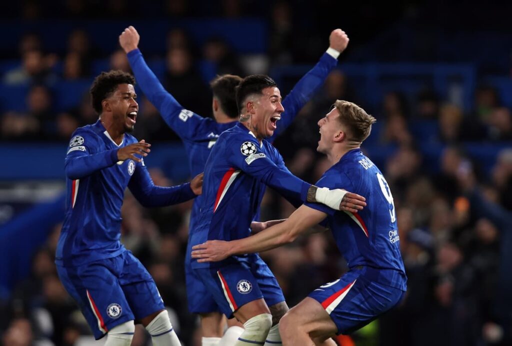 Chelsea players looking dejected on the pitch at Stamford Bridge during a Premier League match.