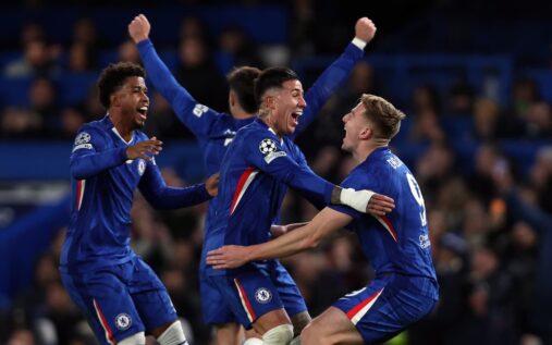 Chelsea players looking dejected on the pitch at Stamford Bridge during a Premier League match.