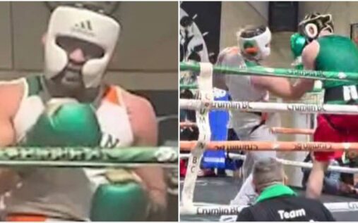 Conor McGregor wearing boxing gloves and protective headgear during an exhibition match in a Dublin boxing ring.