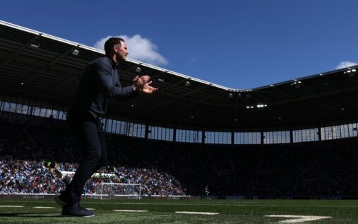 Coventry City supporters waving sky blue flags in the stands at the CBS Arena