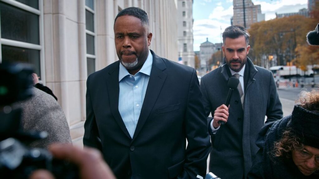 Damon Jones standing on an NBA basketball court wearing team apparel