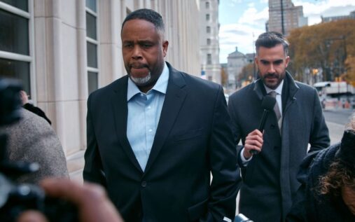 Damon Jones standing on an NBA basketball court wearing team apparel
