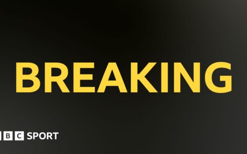 Carlos Alcaraz looking disappointed on a clay tennis court