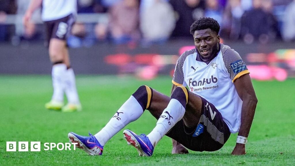Derby County striker Patrick Agyemang receiving medical treatment on the pitch after an ankle injury