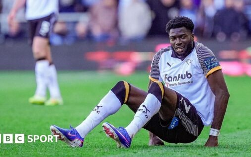 Derby County striker Patrick Agyemang receiving medical treatment on the pitch after an ankle injury