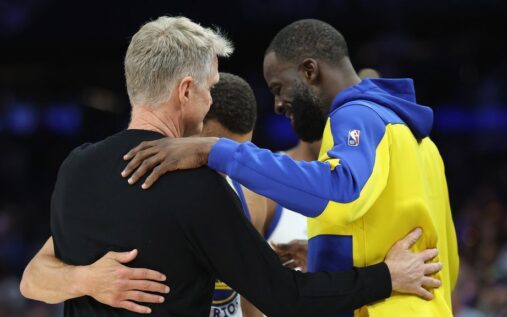 Draymond Green and Steve Kerr talking on the court during a Golden State Warriors basketball game