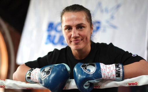 Ellie Scotney posing confidently with her super-bantamweight championship belts